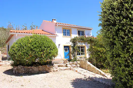 A house with a blue door and a garden